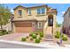 Two story home with a stone front, three steps up to the door, and a two car garage at 424 Vigo Port St, Las Vegas, NV 89138