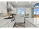 Well-equipped kitchen with stainless steel appliances, mosaic backsplash, and large center island at 424 Vigo Port St, Las Vegas, NV 89138