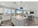 Bright kitchen with a large island, white cabinets, stainless steel appliances, and wood flooring at 424 Vigo Port St, Las Vegas, NV 89138