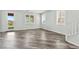 Bright living room with stylish vinyl flooring and view to the backyard with sliding glass door at 424 Vigo Port St, Las Vegas, NV 89138