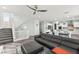 Spacious living room with a staircase, modern decor, gray sofa, and open floor plan at 424 Vigo Port St, Las Vegas, NV 89138