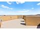 Open roof deck with modern outdoor fireplace and beautiful views of the surrounding landscape under a bright, sunny sky at 424 Vigo Port St, Las Vegas, NV 89138
