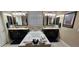 Bathroom with double vanity, soaking tub, dark cabinets, and two mirrors at 4242 Helena Hideaway Ct, Las Vegas, NV 89129
