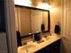Bathroom featuring a dual sink vanity with modern fixtures and decor at 4242 Helena Hideaway Ct, Las Vegas, NV 89129
