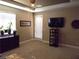 Flex room with wall-mounted TV, desk, neutral carpet, recessed lights and access to the outside at 4242 Helena Hideaway Ct, Las Vegas, NV 89129