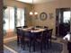 Cozy dining room with large windows, plantation shutters, and a traditional dining set at 4242 Helena Hideaway Ct, Las Vegas, NV 89129