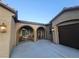 Inviting entryway with covered porch, seating area, and direct access to the garage at 4242 Helena Hideaway Ct, Las Vegas, NV 89129