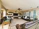 Spacious living room features dual couches, a ceiling fan, shutters, and built-in shelves at 4242 Helena Hideaway Ct, Las Vegas, NV 89129