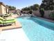 Inviting in-ground pool with lounge chairs at 4242 Helena Hideaway Ct, Las Vegas, NV 89129