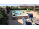 Inviting backyard pool and spa area with comfortable lounge chairs and shaded seating at 4242 Helena Hideaway Ct, Las Vegas, NV 89129