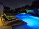Night shot of the in-ground pool with neon blue lights at 4242 Helena Hideaway Ct, Las Vegas, NV 89129