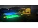 Inviting backyard pool and spa with lounge area, pergola, and ambient lighting for relaxing evenings at 4242 Helena Hideaway Ct, Las Vegas, NV 89129