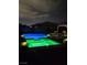 Inviting backyard pool and hot tub with decorative lights creating a relaxing nighttime ambiance at 4242 Helena Hideaway Ct, Las Vegas, NV 89129