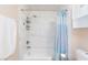 Bright bathroom featuring white tile and shower/tub combination with blue shower curtain at 45 N Lamb Blvd, Las Vegas, NV 89110