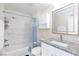 Well-lit bathroom featuring a tub with shower, toilet, and vanity with sink and mirror at 45 N Lamb Blvd, Las Vegas, NV 89110