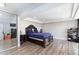Primary bedroom with a large bed, wood floors, custom ceiling, and sliding glass door at 45 N Lamb Blvd, Las Vegas, NV 89110
