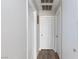 Hallway with white trim and doors, wood-look floors, and neutral colored walls at 45 N Lamb Blvd, Las Vegas, NV 89110