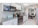 Updated kitchen with granite countertops, white cabinets, stainless steel appliances, and mosaic backsplash at 45 N Lamb Blvd, Las Vegas, NV 89110