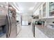 Well-lit kitchen with granite countertops, white cabinetry, stainless steel appliances, and tile floors at 45 N Lamb Blvd, Las Vegas, NV 89110