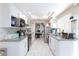 Functional kitchen layout with granite countertops, white cabinets, stainless appliances, and backsplash at 45 N Lamb Blvd, Las Vegas, NV 89110