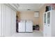 Bright laundry area featuring a washer, dryer, white cabinetry, and tile floors at 45 N Lamb Blvd, Las Vegas, NV 89110