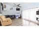 Bright living room with high ceilings, ceiling fan, hardwood floors, and comfortable seating at 45 N Lamb Blvd, Las Vegas, NV 89110