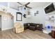 Comfortable living room with leather furniture, a ceiling fan, and modern decorations on the wall at 45 N Lamb Blvd, Las Vegas, NV 89110