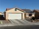 Charming single-story home with a two-car garage, desert landscaping, and roof-mounted solar panels at 4636 Ferrell St, North Las Vegas, NV 89031
