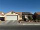 Charming single-story home with a two-car garage, desert landscaping, and roof-mounted solar panels at 4636 Ferrell St, North Las Vegas, NV 89031