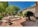 Private backyard with hot tub, desert landscaping, and ample space for outdoor relaxation at 467 Beardsley Cir, Henderson, NV 89052