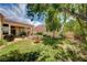Beautiful backyard with a lush lawn, mature trees, and relaxing water feature at 467 Beardsley Cir, Henderson, NV 89052