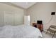Bedroom featuring a large bed, sliding door closet and dark wooden desk at 467 Beardsley Cir, Henderson, NV 89052
