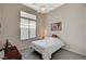 Well lit bedroom featuring a window, ceiling fan and dark wooden furniture at 467 Beardsley Cir, Henderson, NV 89052