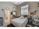 Cozy bedroom featuring a plush bed, a sunny window, and comfortable furnishings at 467 Beardsley Cir, Henderson, NV 89052