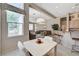Bright dining area open to the living room features a large window and modern lighting at 467 Beardsley Cir, Henderson, NV 89052