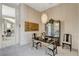 Cozy dining area with stylish chandelier, seating for four, and mirrored buffet at 467 Beardsley Cir, Henderson, NV 89052