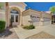 Lovely desert landscaping compliments the exterior of this home with a three-car garage at 467 Beardsley Cir, Henderson, NV 89052