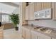 Close-up of the kitchen with modern appliances and view to the living room at 467 Beardsley Cir, Henderson, NV 89052
