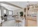 Open kitchen and living space with a breakfast bar and stainless steel appliances at 467 Beardsley Cir, Henderson, NV 89052
