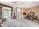 Bright living room with neutral tones, a ceiling fan, and access to the backyard at 467 Beardsley Cir, Henderson, NV 89052