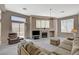 Inviting living room with ample seating, fireplace, and access to the outdoor patio at 467 Beardsley Cir, Henderson, NV 89052