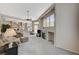 Open-concept living room flows into kitchen, featuring high ceilings and natural light at 467 Beardsley Cir, Henderson, NV 89052