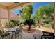 Charming patio featuring outdoor seating and a view of the landscaped backyard at 467 Beardsley Cir, Henderson, NV 89052