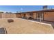 Cozy backyard featuring a covered patio and gravel landscaping, perfect for outdoor gatherings at 4735 Madrigal Way, Las Vegas, NV 89122