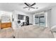 Bedroom with desk, TV, ceiling fan, and view to the backyard at 4735 Madrigal Way, Las Vegas, NV 89122