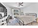 Bedroom with desk, patio access, ceiling fan, and large bed at 4735 Madrigal Way, Las Vegas, NV 89122