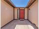 Inviting front entrance featuring a red door and sidelight window, creating a warm welcome at 4735 Madrigal Way, Las Vegas, NV 89122