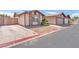 Street view of a single-story home with low maintenance landscaping and a two-car garage at 4735 Madrigal Way, Las Vegas, NV 89122