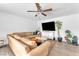 Comfortable living room with a large sectional sofa, TV, and potted plants at 4735 Madrigal Way, Las Vegas, NV 89122