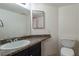 Cozy bathroom featuring a sink with a modern faucet, a mirror, and a toilet at 499 Kristin Ln, Henderson, NV 89011